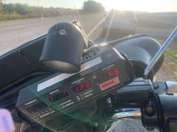 A radar device showing a reading of 122 kilometres per hour is seen on an OPP motorcycle on Highway 3 in Kingsville, September 16, 2025. Photo courtesy OPP West Region/X.